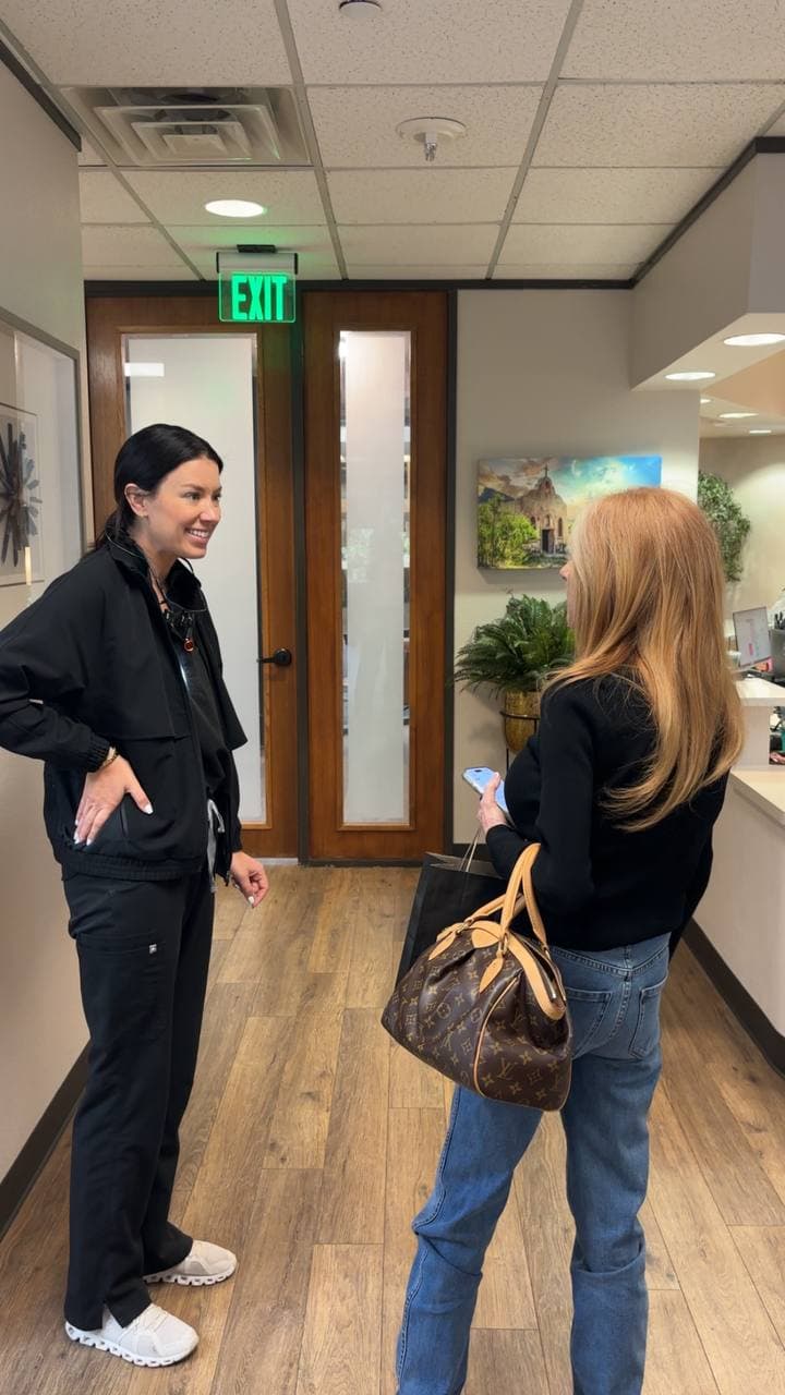 Dr. Gonzales chatting with a patient in the lobby at The Smile Suite