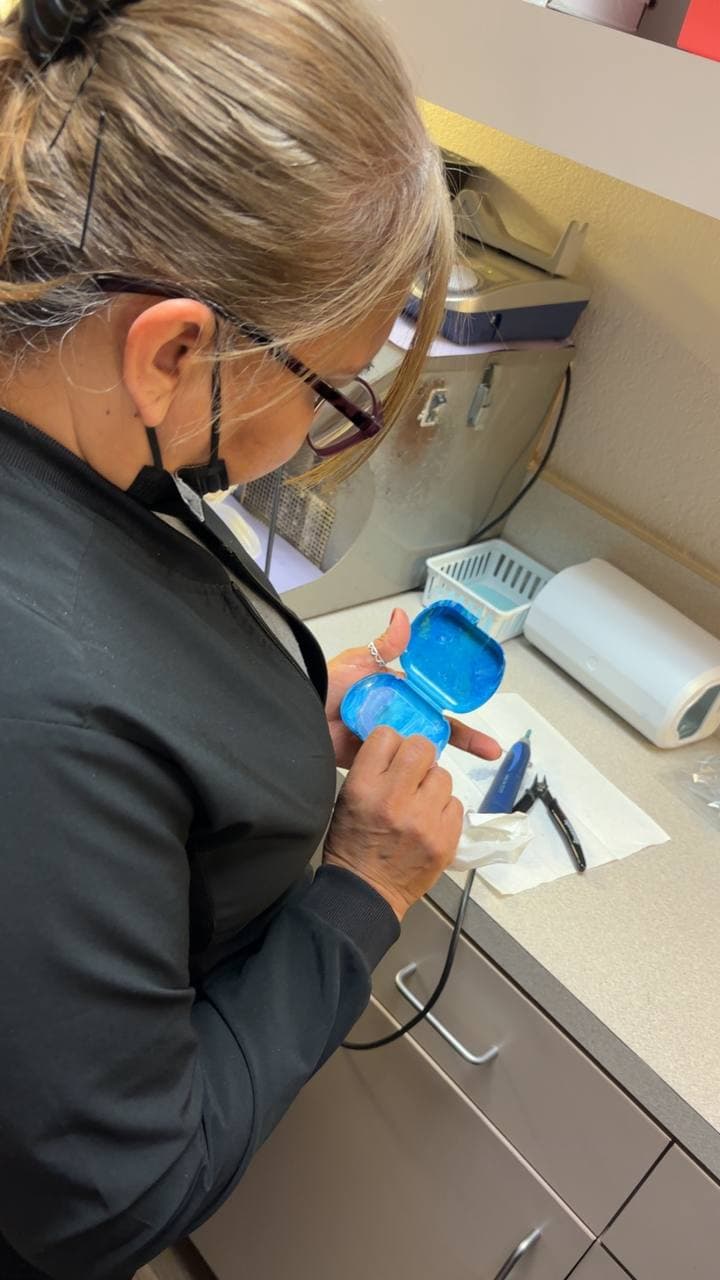 Dental staff working with retainer mold at The Smile Suite lab